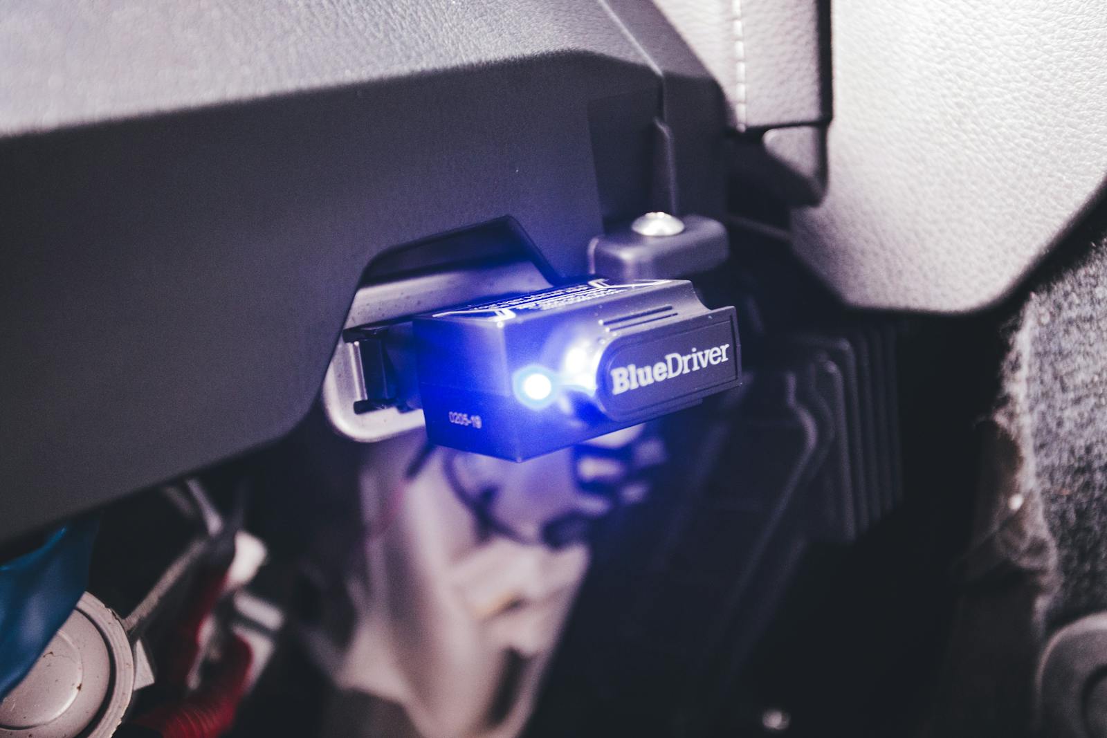 OBD2 dongle plugged into a vehicle diagnostic port