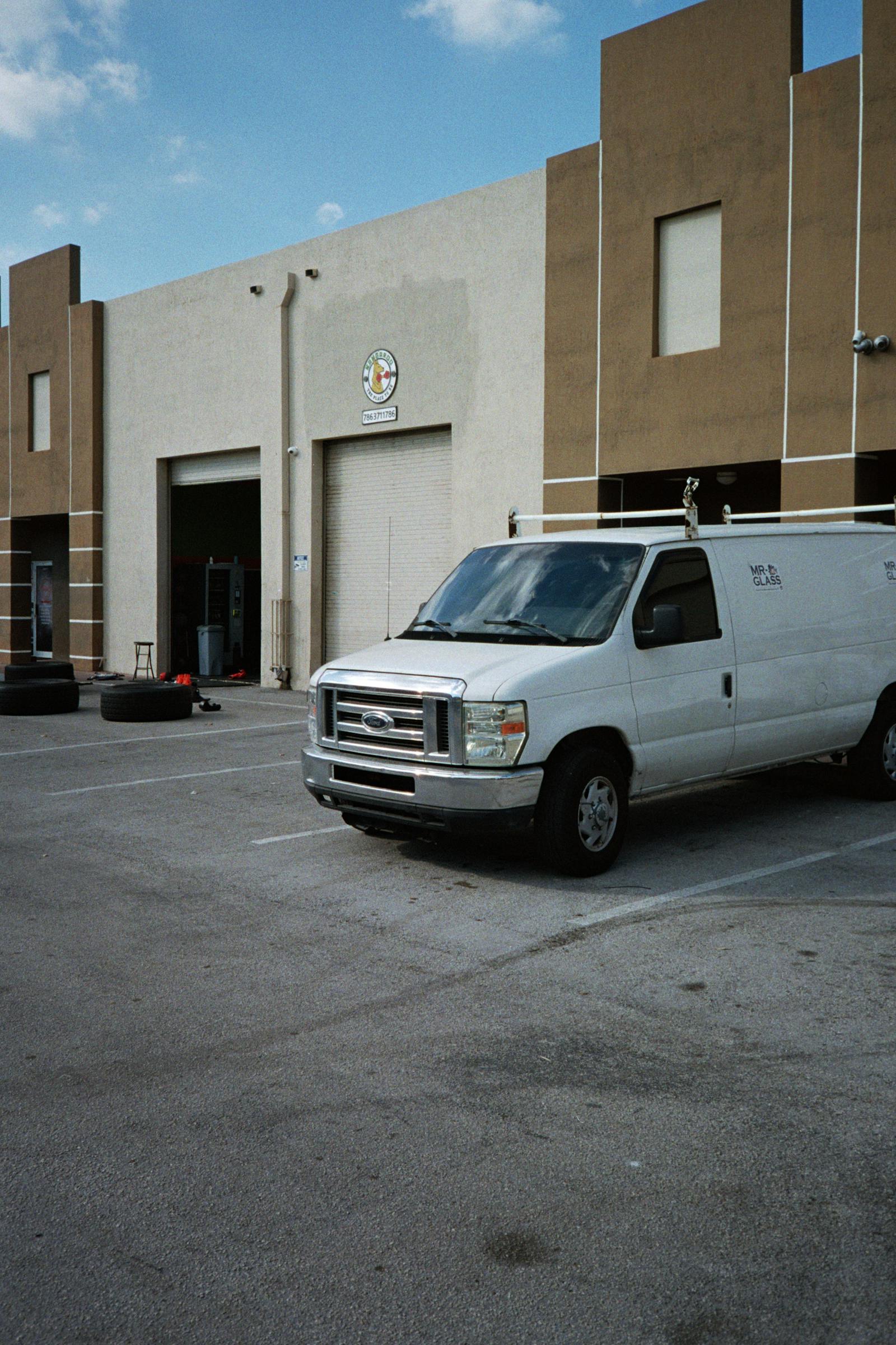 Commercial cargo van being loaded outside a warehouse