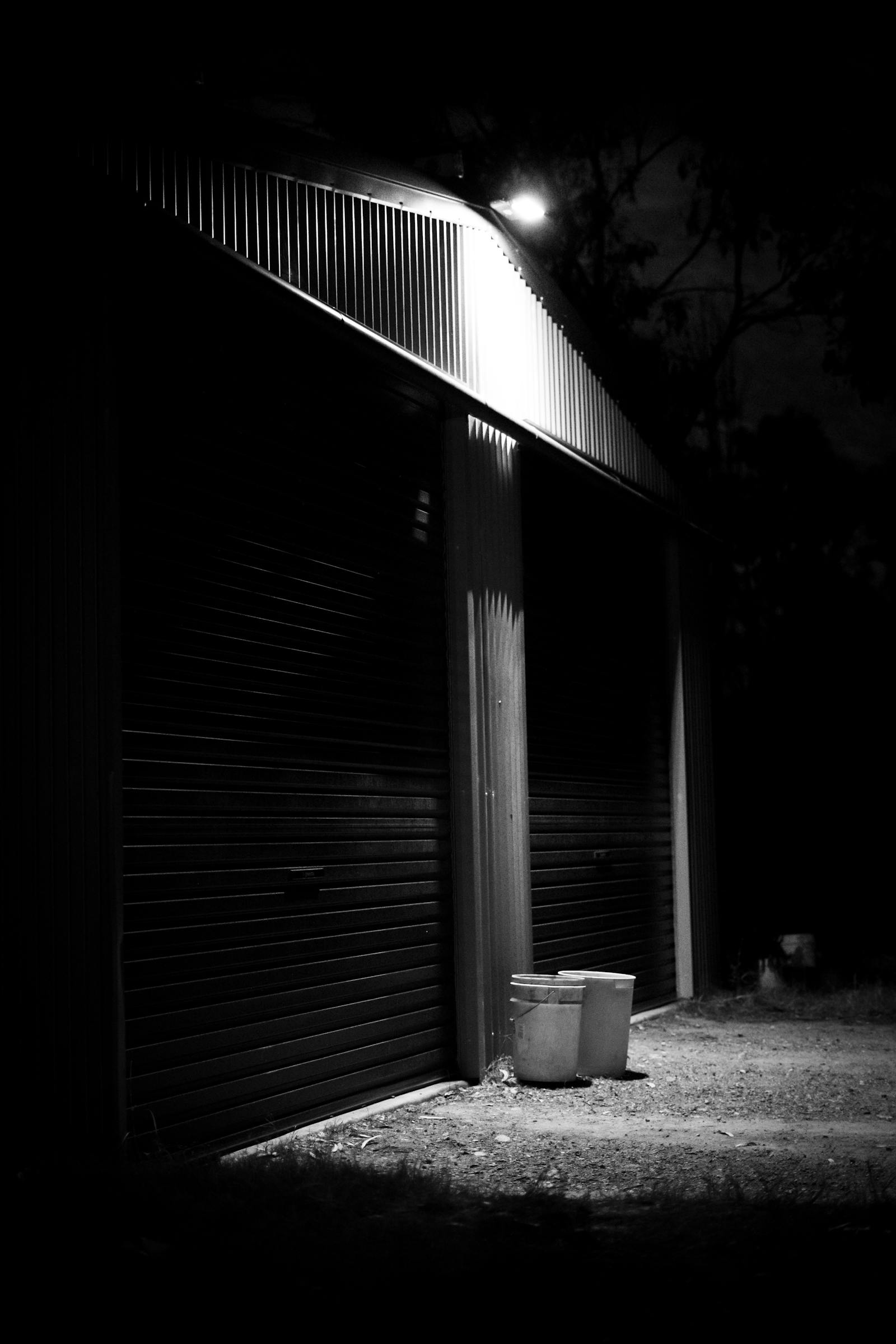 Dramatic empty garage scene at night with directional lighting