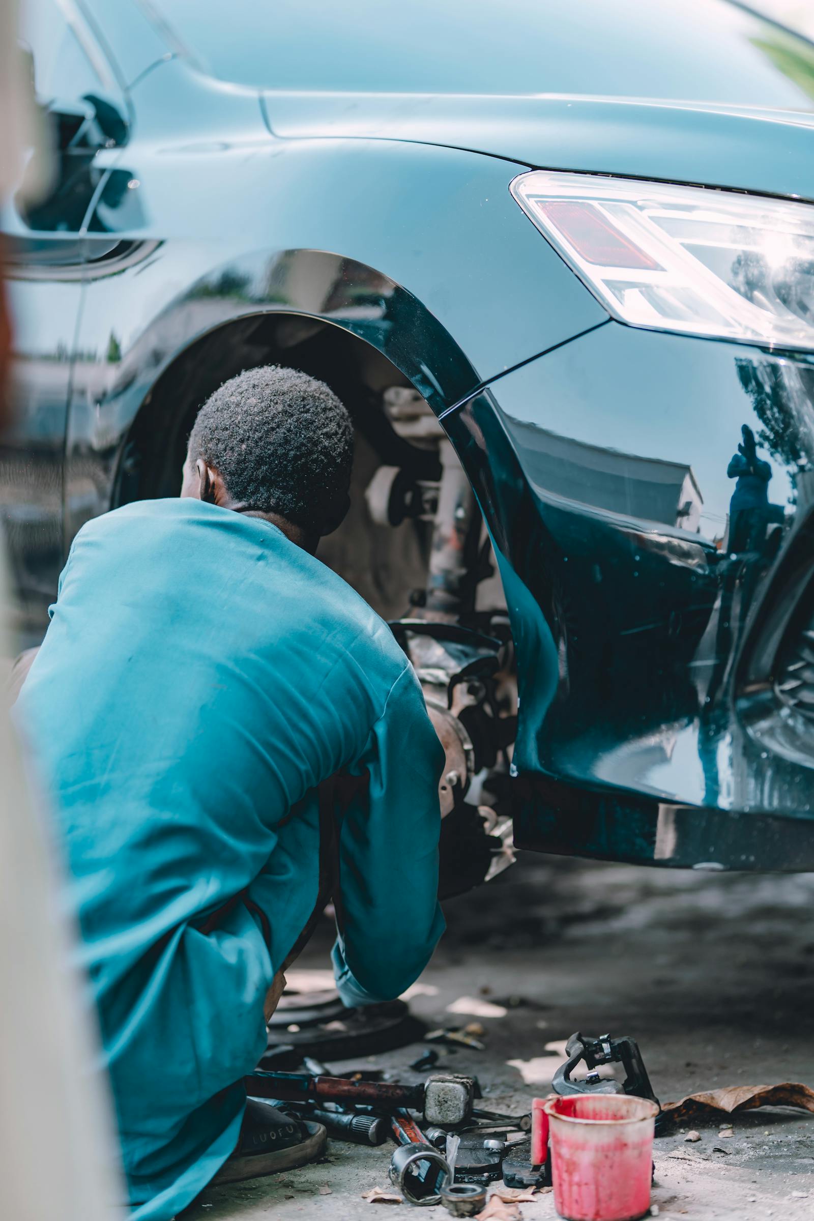 Mechanic working on a brake assembly with the wheel removed