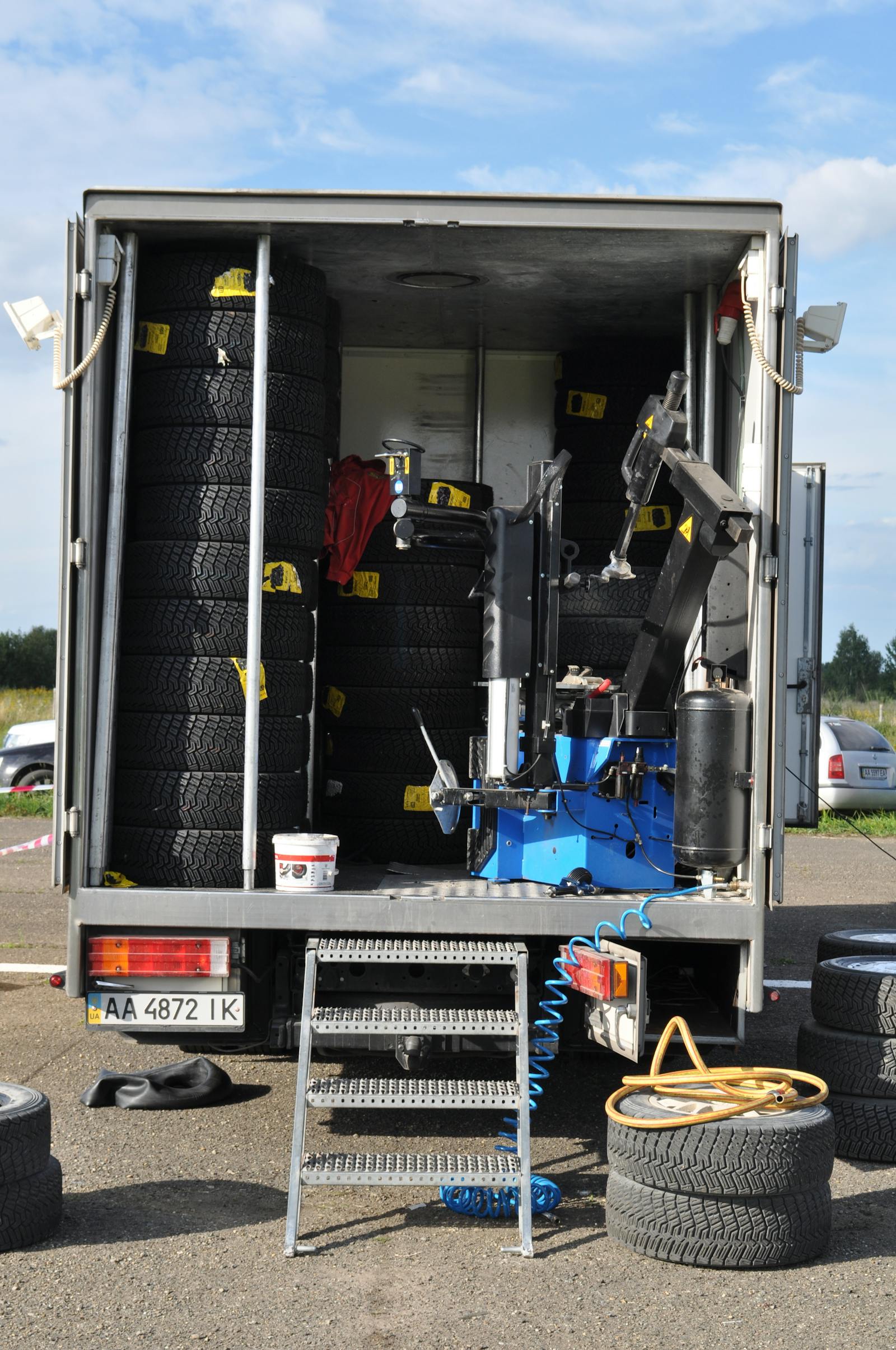Mobile tire repair service truck parked roadside with hazard cones — the day-one mobile-mechanic setup