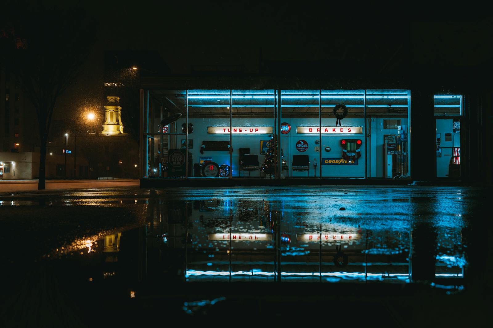 Old auto garage at night with vintage Tune-Up and Brakes neon signage