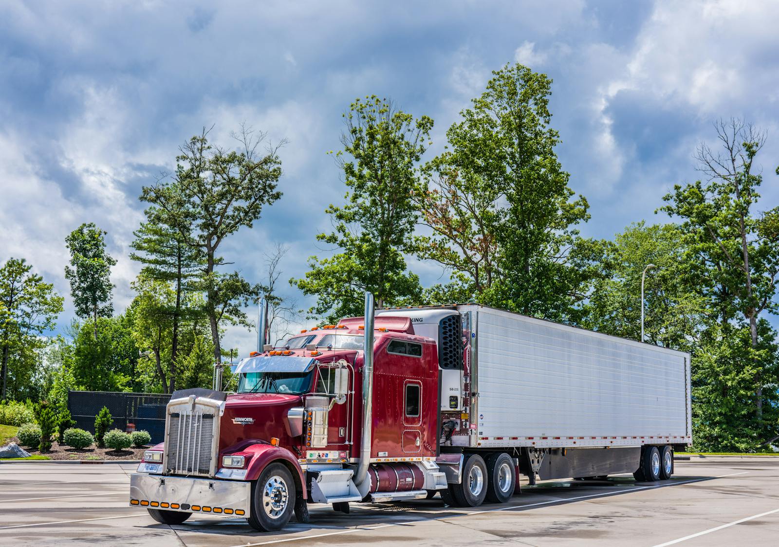 Red semi truck parked at an industrial yard