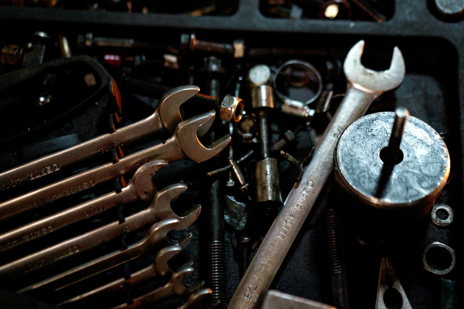 Wrenches and parts scattered on a workshop bench mid-job
