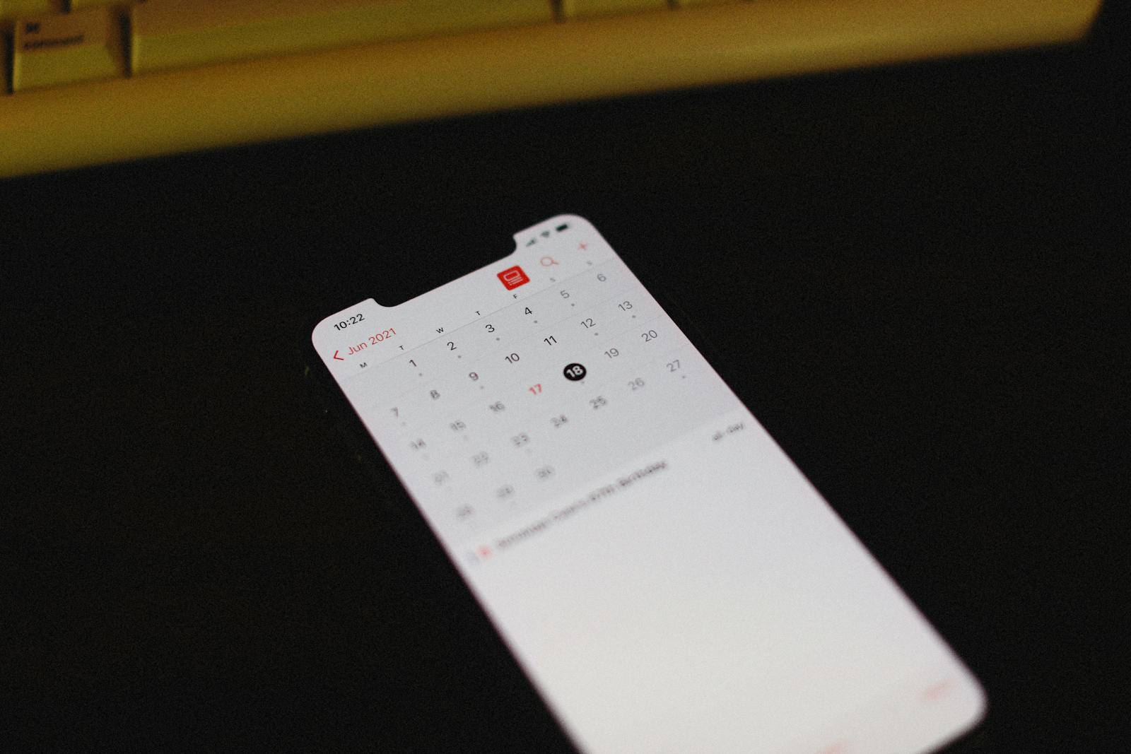 Smartphone showing a calendar/scheduler glowing in low light