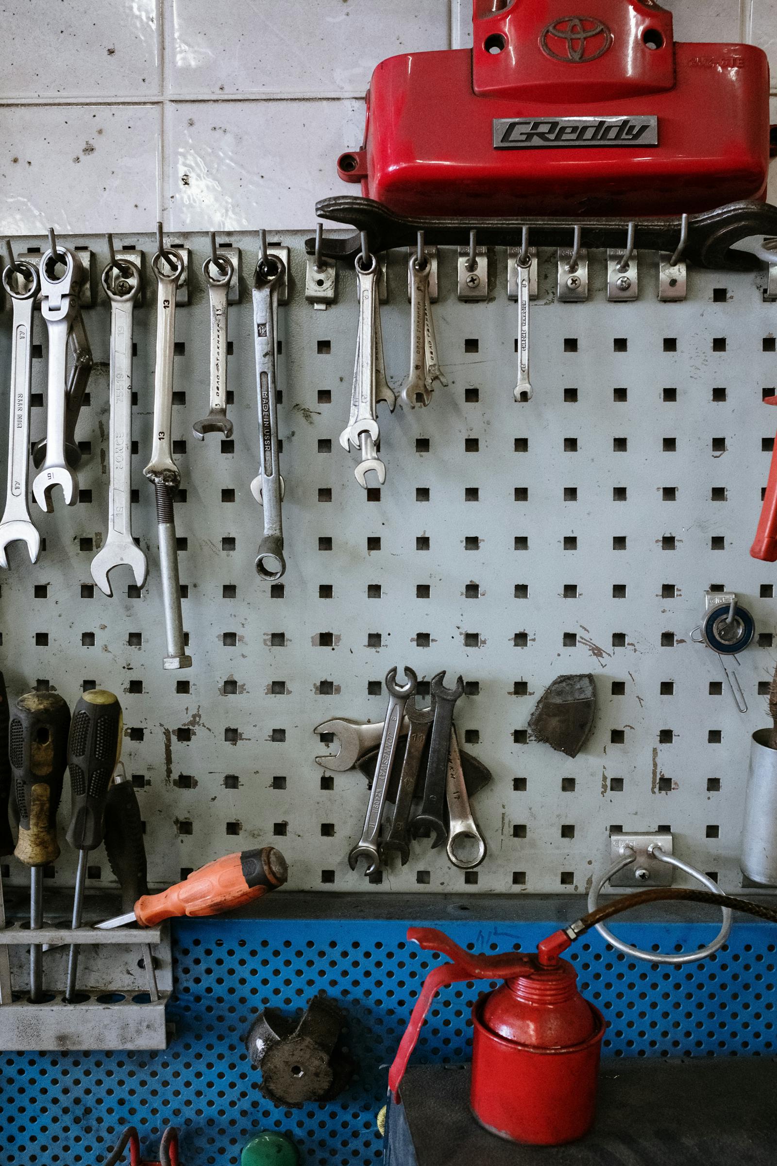 Hand tools organized on a workshop pegboard