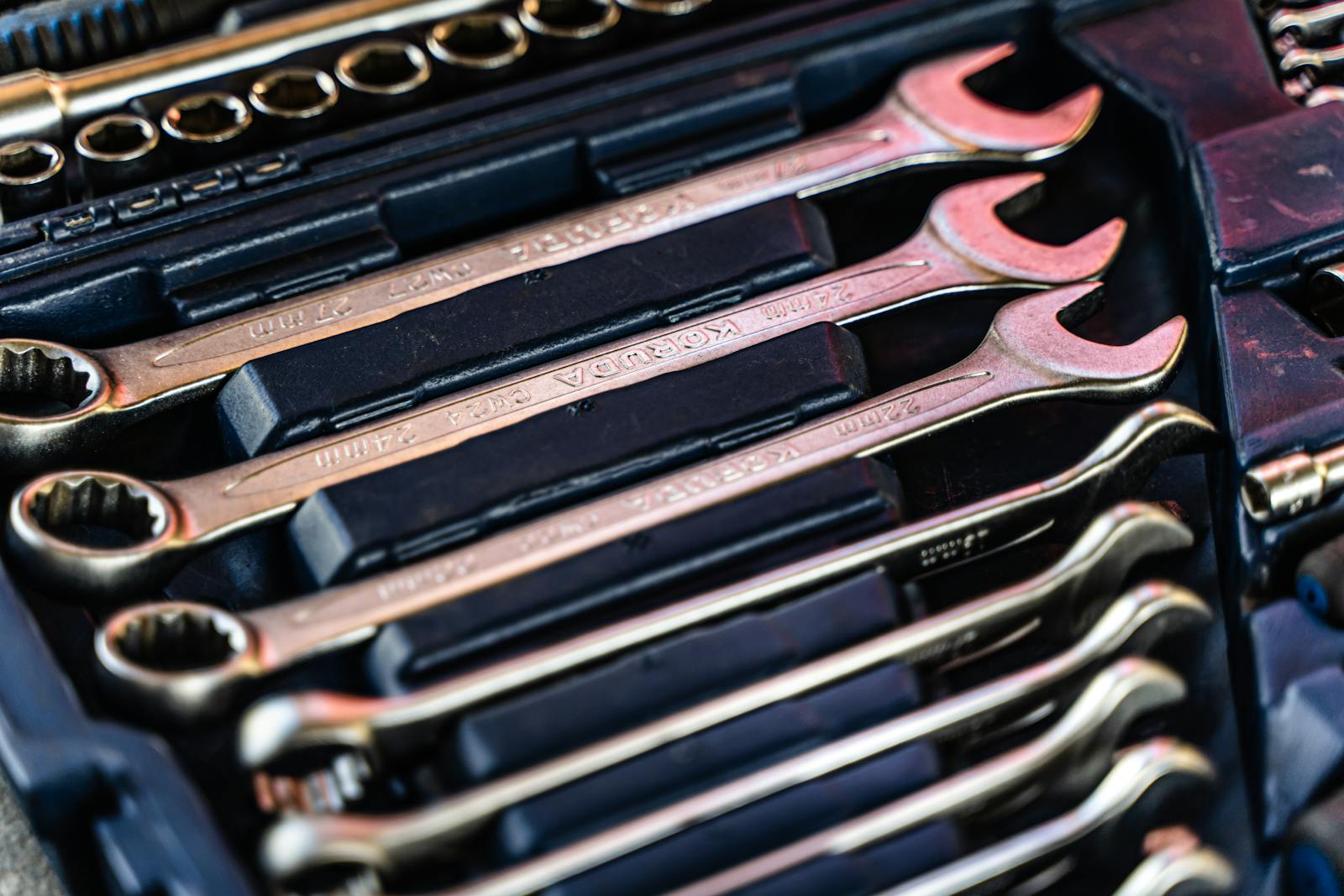 Combination wrenches arranged in a red toolbox case
